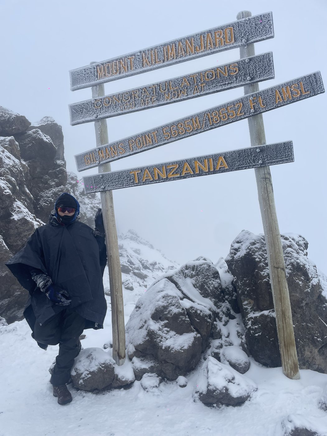 Katiana at the Kilimanjaro summit sign